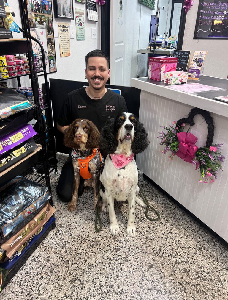 Eduardo poses with two dogs